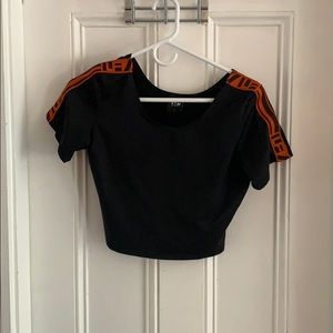 LF black crop top with orange LF detail on sleeve